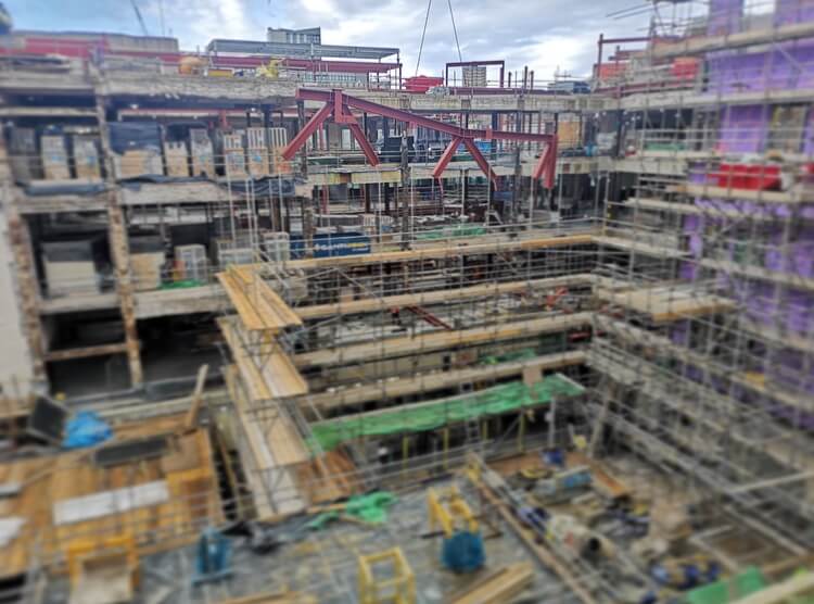 Steel truss being lowered onto a construction site by a crane at Plymouth Cross Steel truss being lowered onto a construction site by a crane at Plymouth Cross